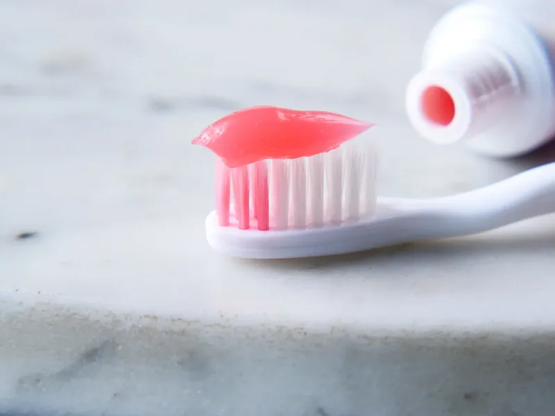 Toothpaste on a toothbrush for a daily oral hygiene routine